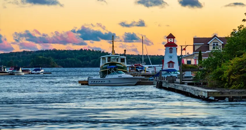 A boat is docked at the pier of a harbor.