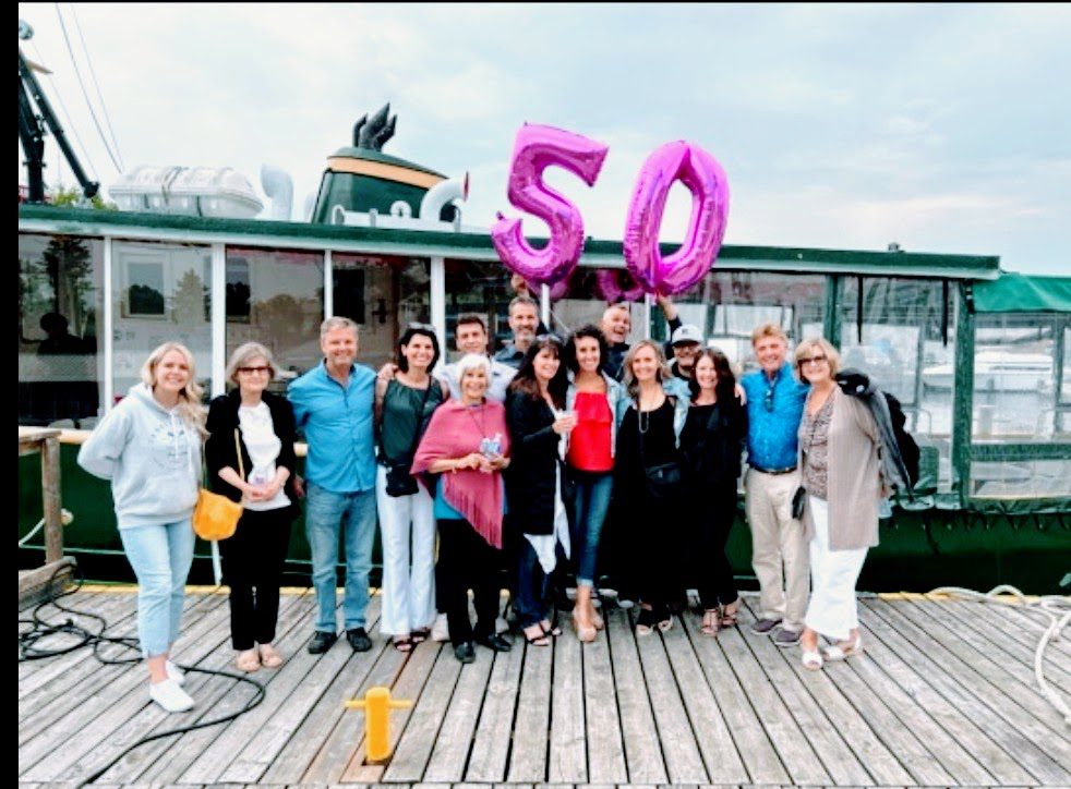 A group of people standing on top of a dock.